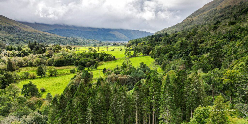 An aerial view of western scotland glenn - very green trees and rolling hills