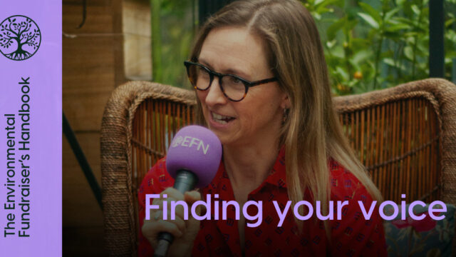 A white woman with blonde hair, Louise, is speaking into a purple microphone with the EFN logo on whilst sitting in a wicker chair in a greenhouse. Purple writing over the top says Finding you voice and The Environmental Fundraiser's Handbook.