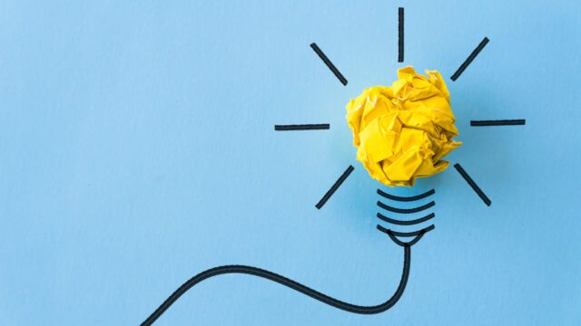 A lightbulb drawing with a yellow light on blue background